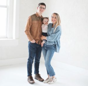 Deacon Jesse Dudek with his wife, Avery, and their daughter, Florence.